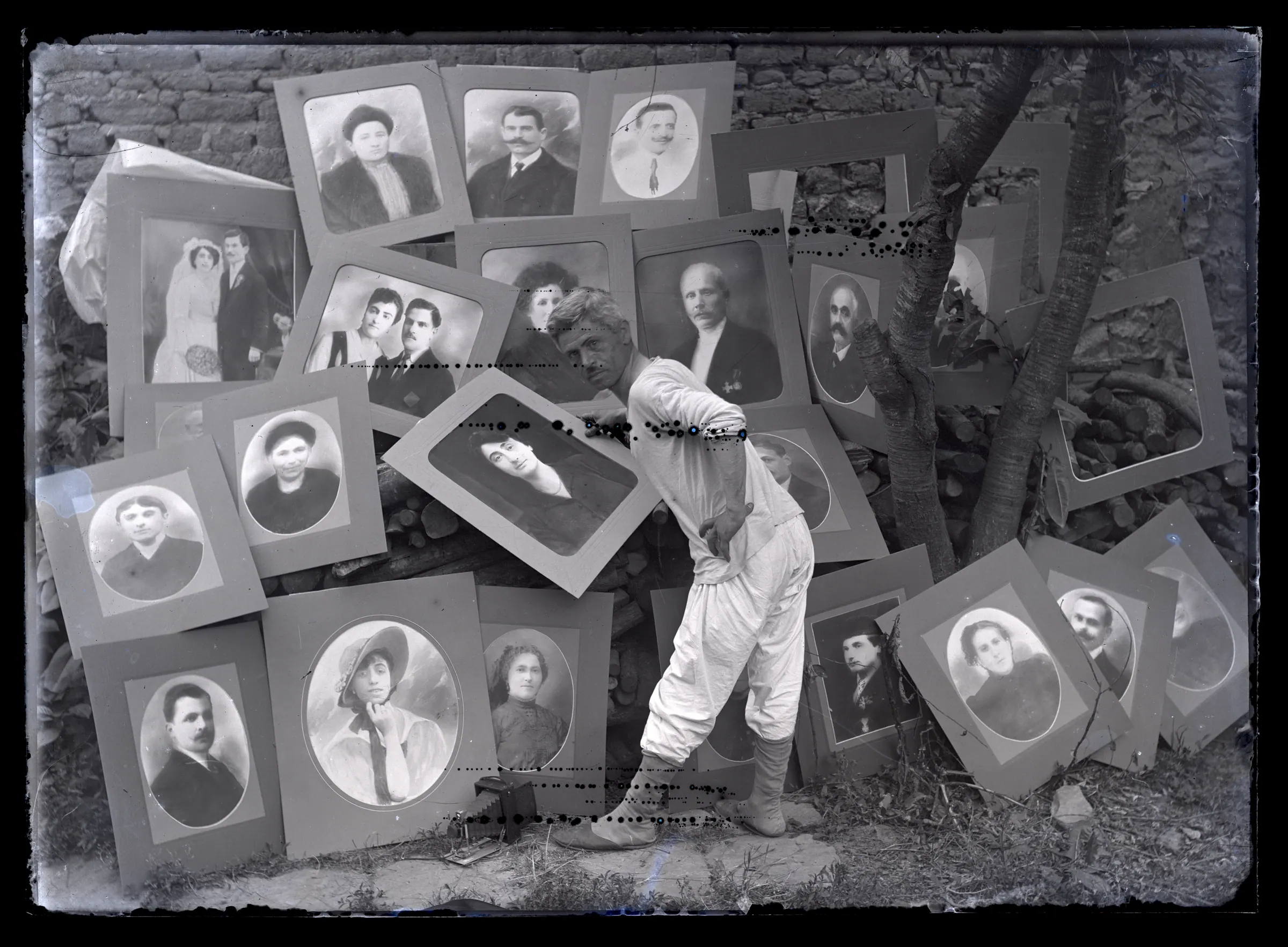 Ianaki Manakia in his underclothes, in front of the portraits, Plovdiv