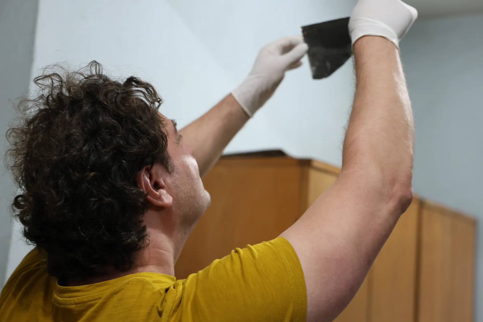 Cătălin D. Constantin examining a glass plate at the Bitola Archive